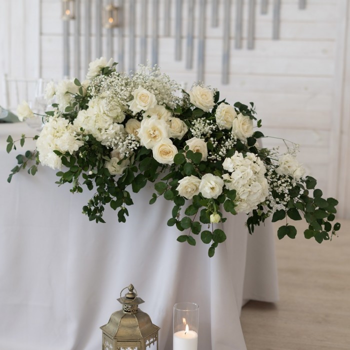 Композиция из белых гортензий и роз на стол молодоженов