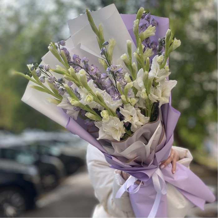 11 белых гладиолусов с дельфиниумом